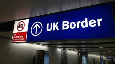 An airport sign reading 'UK Border'
