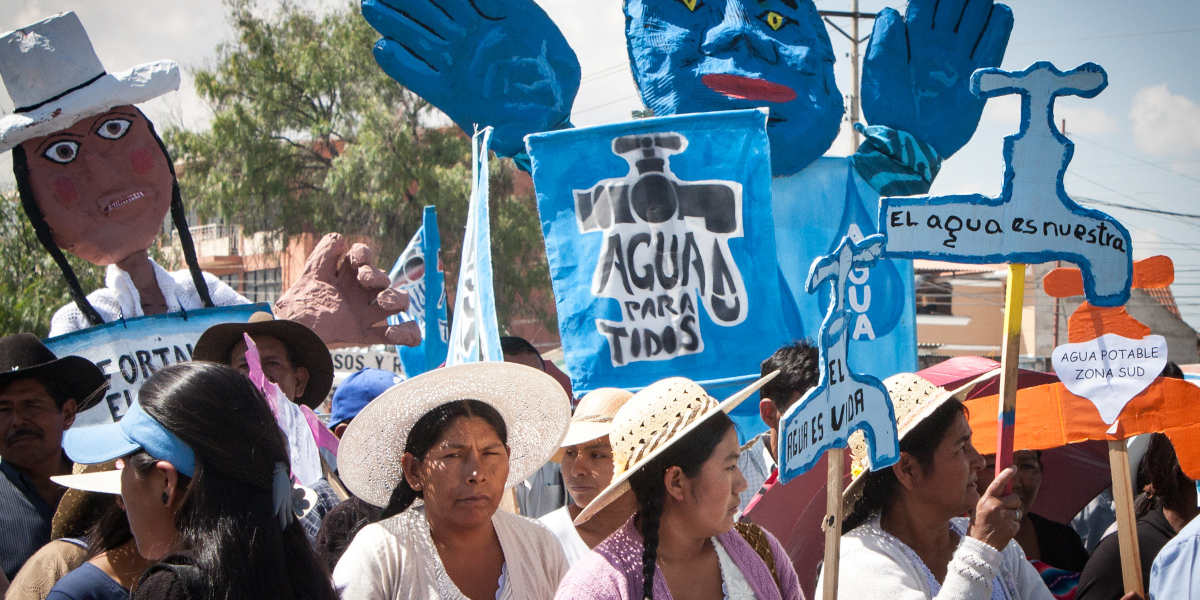 A rally with marking the tenth anniversary of the Cochabamba water war, with effigies and placards bearing messages like reading 'water for everyone'