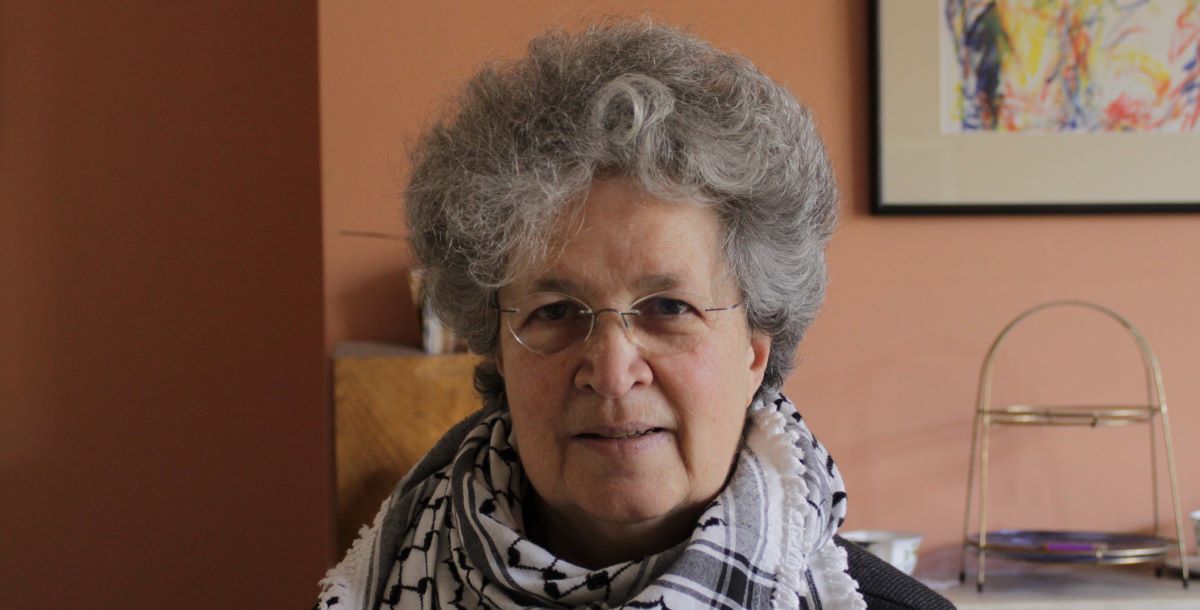 Photo of Diane Langford wearing a Keffiyeh