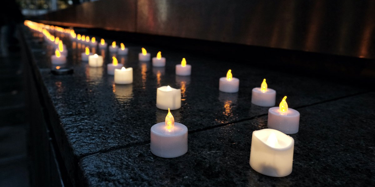 Rows of candles lit for a vigil outside the Home Office