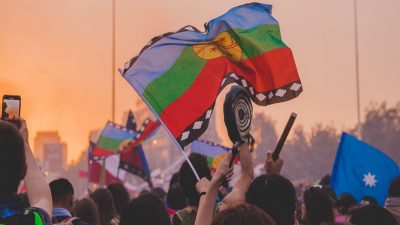 Protesters wave the Mapuche flag on the streets of Chile