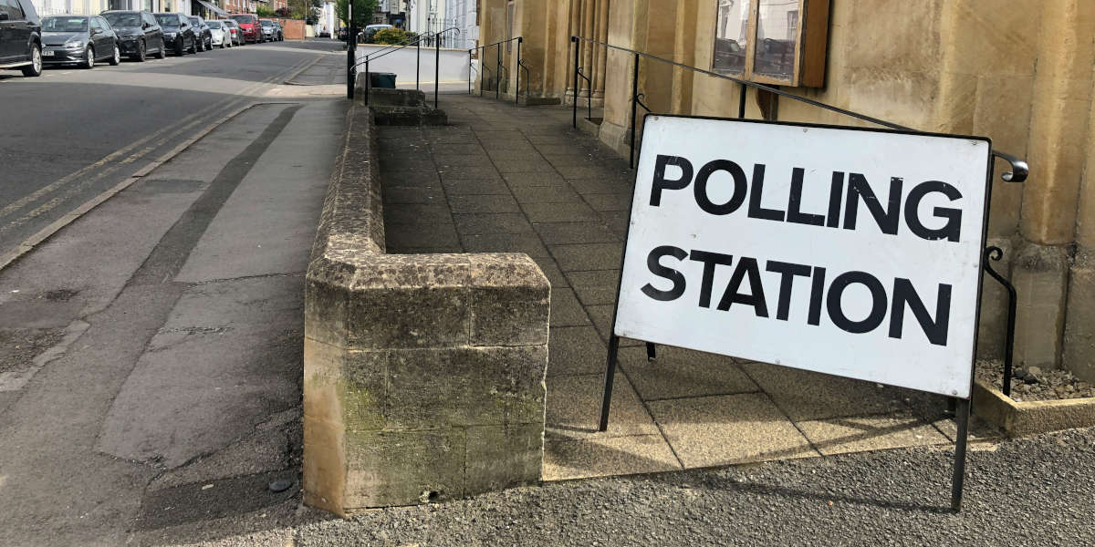 A photo of a polling station with a sign outside it