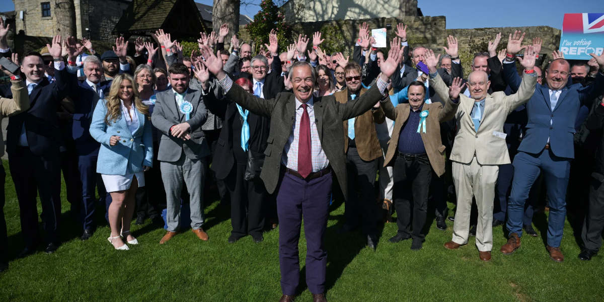 A group photo of celebrating Reform UK councillors and activists in Durham, with party leader Nigel Farage in the centre