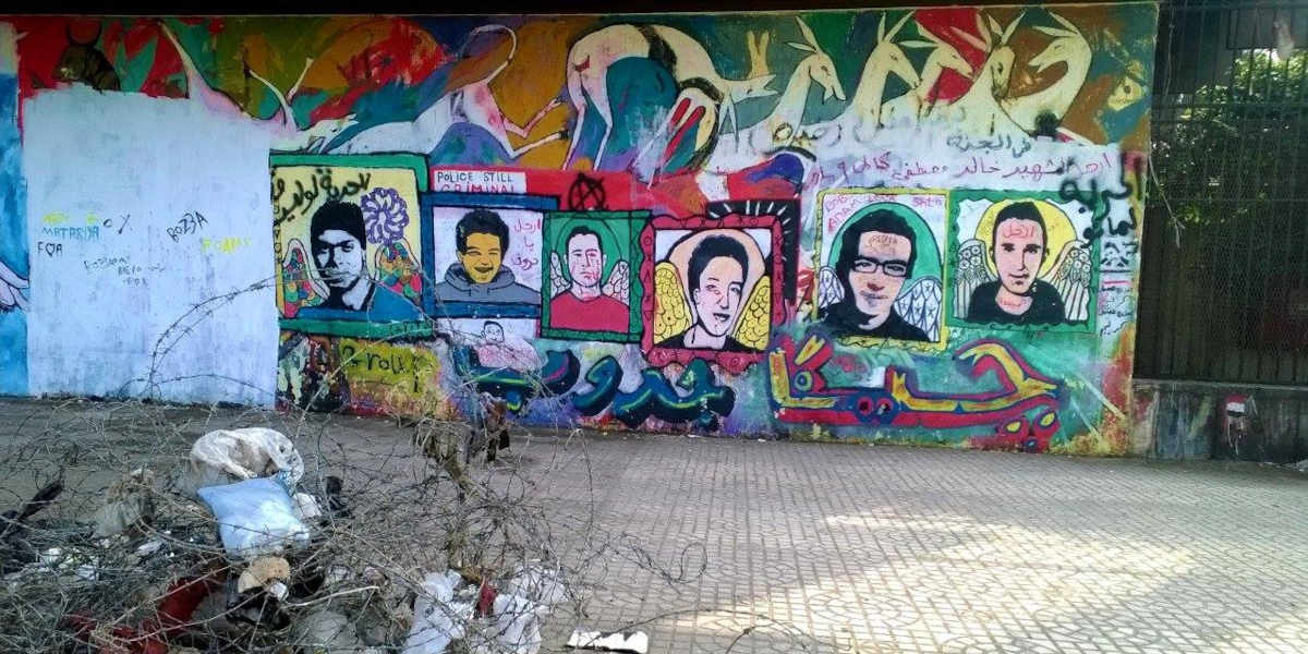 A mural painted onto a wall with six faces, showing people who were killed during the popular uprising in Tahrir Square