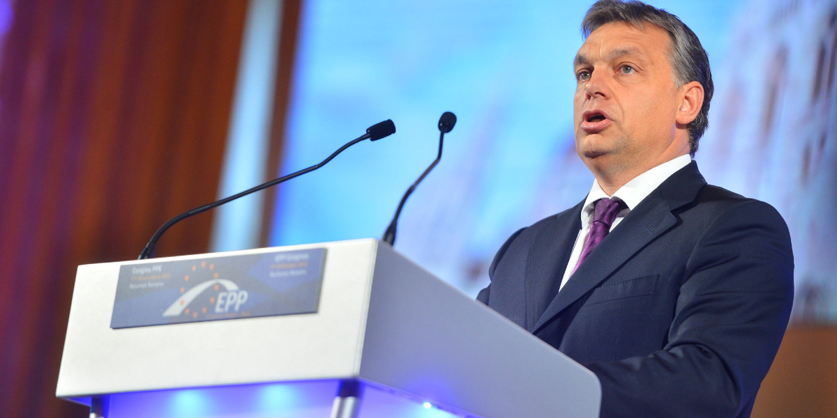 Hungarian Prime Minister speaking behind a lectern with the logo of the European People's Party (EPP) on it